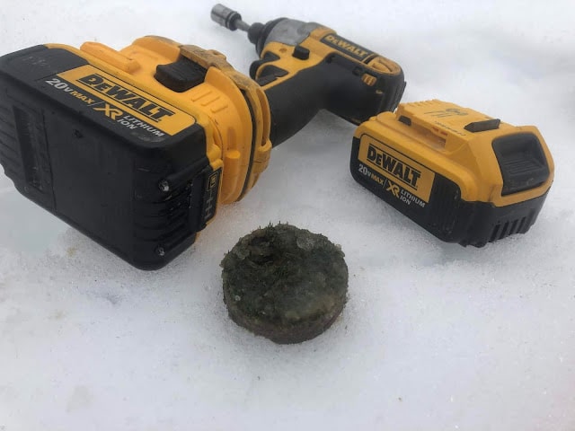 A DeWalt Drill taking samples of the green below the ice.