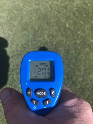 Another close up view of a thermometer reading the greens surface temperature. It reads 20 Celsius.