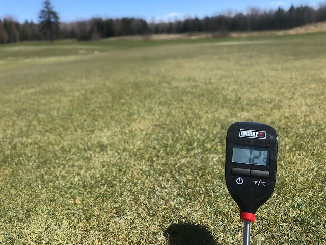 A soil temperature thermometer reading 12 celsius.