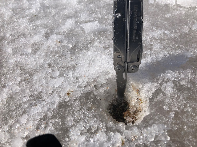 There is an instrument measuring 3 inches of ice on top of the number 10 green.